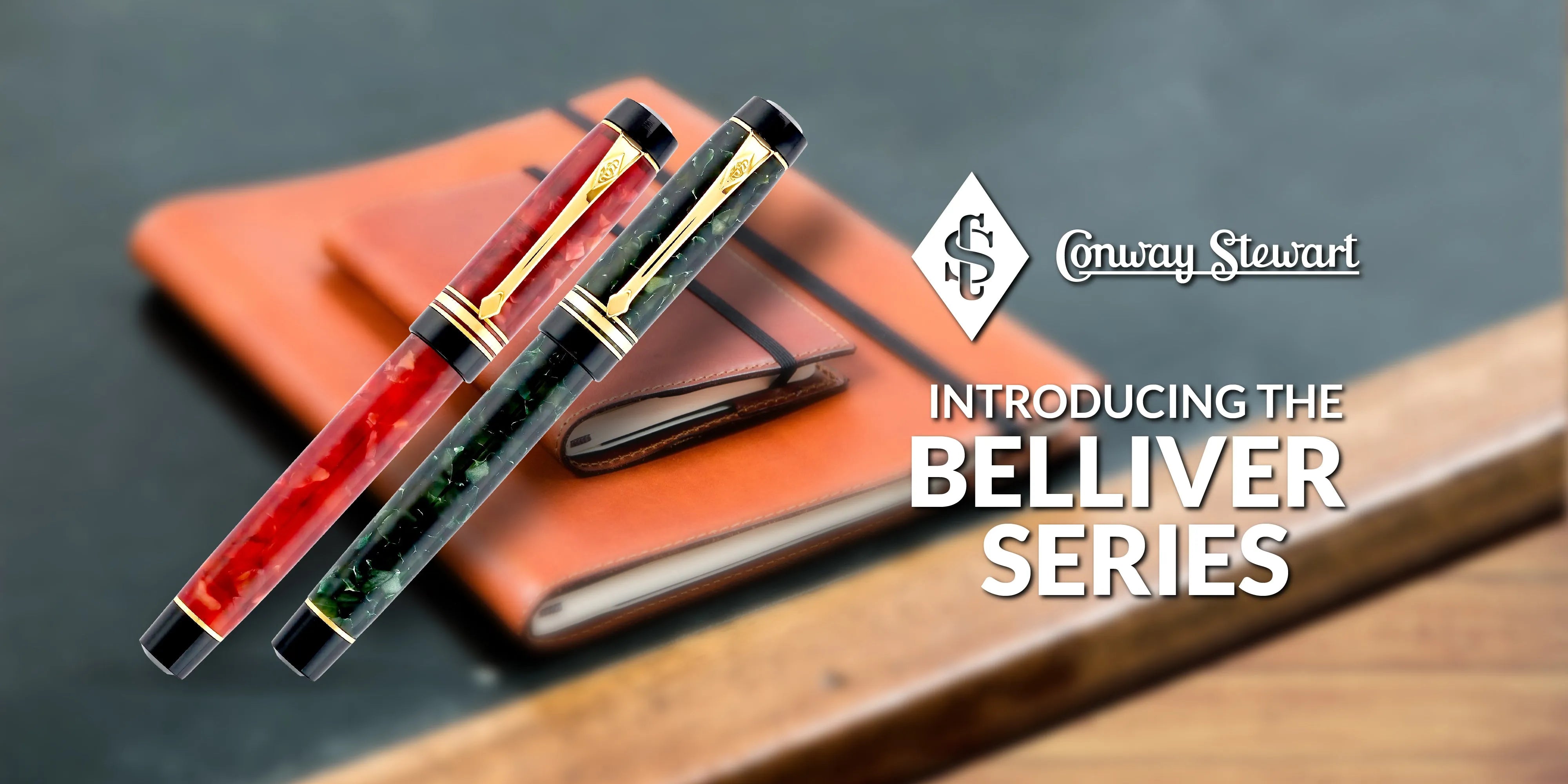 Banner for the Belliver Series, red and green marbled fountain pens resting on a tan leather notebook