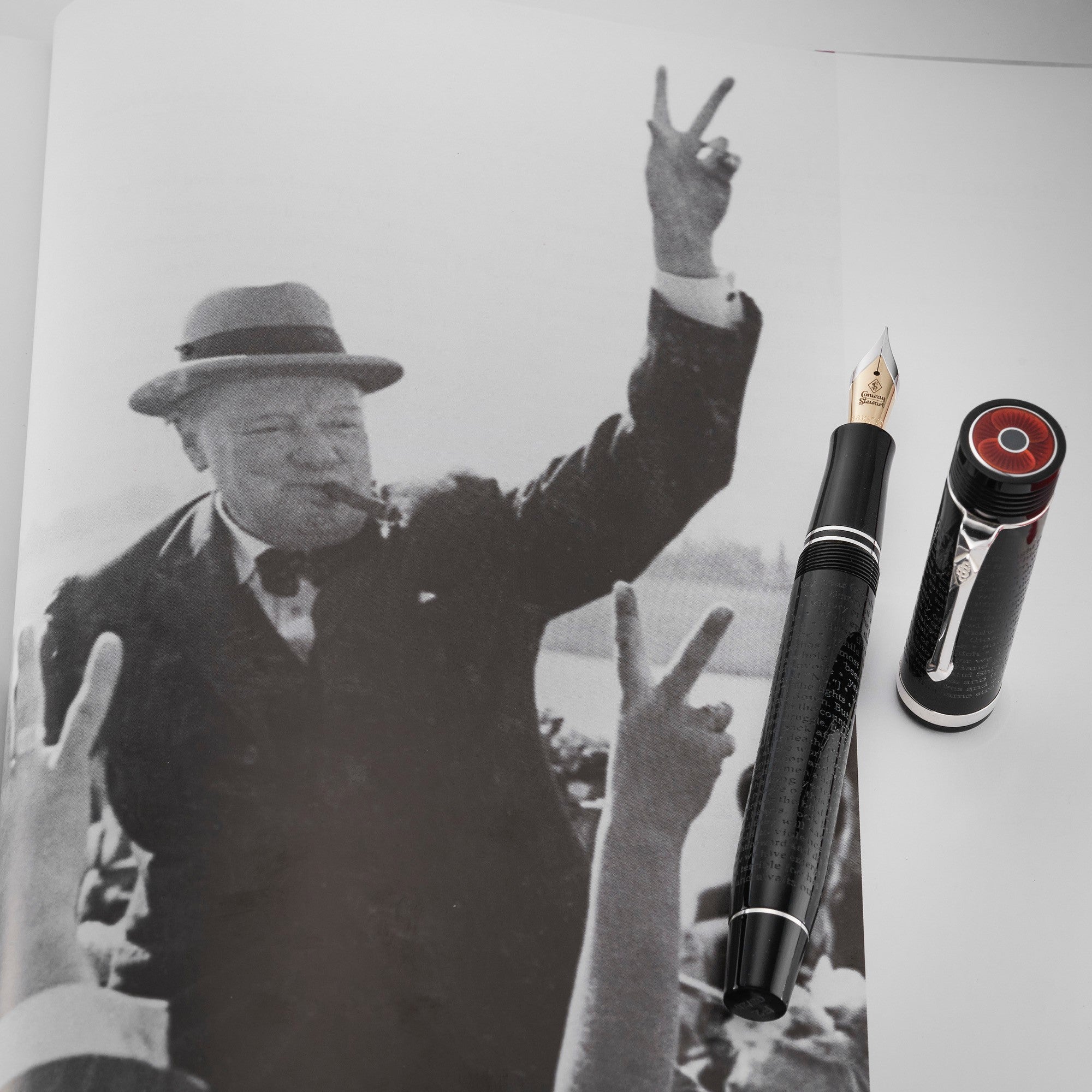 VE-Day pen beside a photograph of Churchill giving the V for victory sign with a cigar