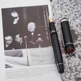 VE-Day pen beside a book page showing Churchill greeting crowds from a balcony on VE Day 1945