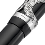 Macro of the cap band hallmarked HCS, 925, between the silver serpent design and black barrel