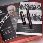 Their Finest Hour Bordeaux Fountain Pen resting on a Churchill speeches book beside the hallmarks booklet