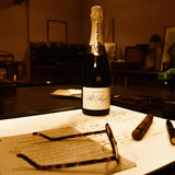 The Pol Roger 175th Anniversary fountain pen on a desk with a Pol Roger champagne bottle, cigar, and bust