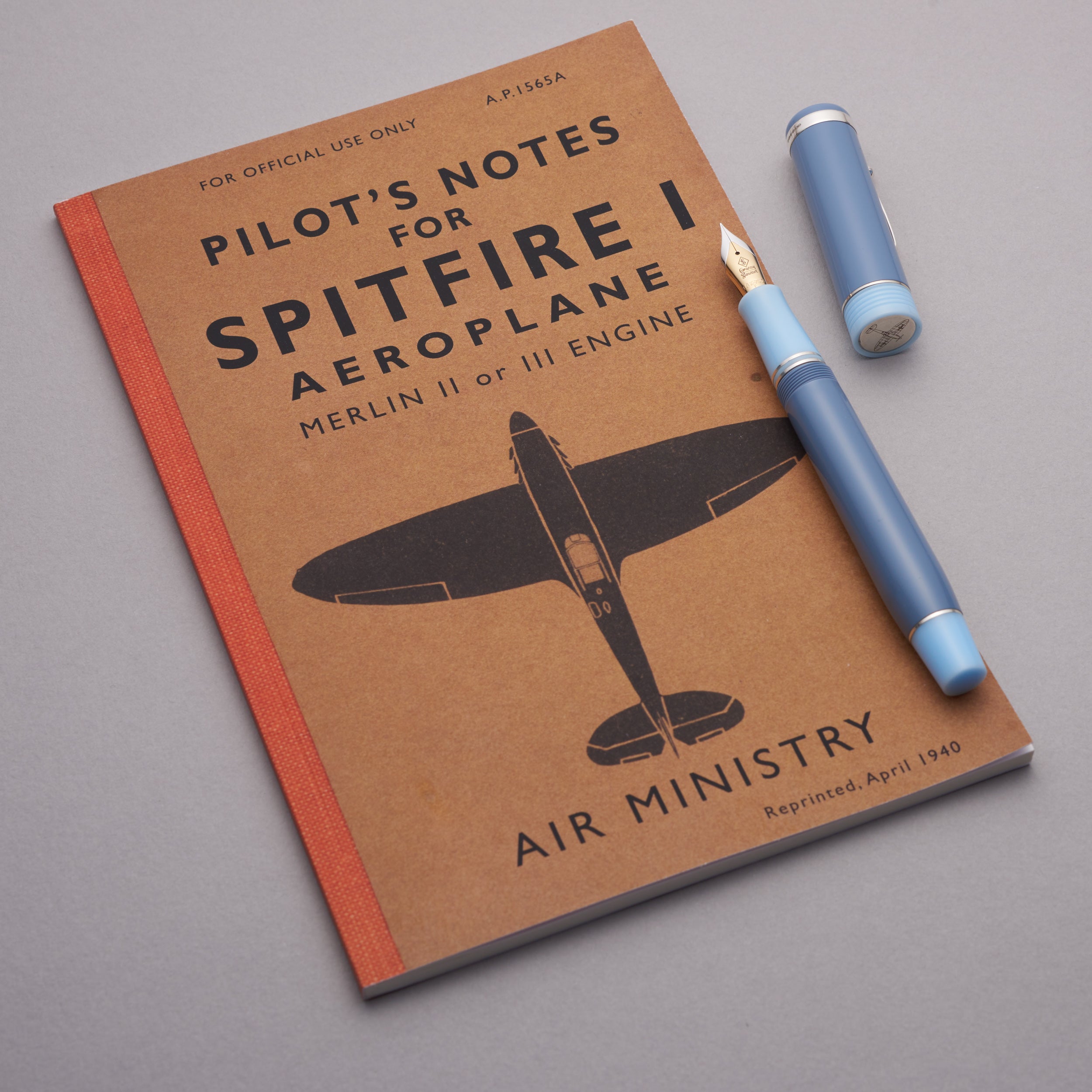 Conway Stewart Spitfire fountain pen resting on a vintage Pilot's Notes for Spitfire I Aeroplane booklet