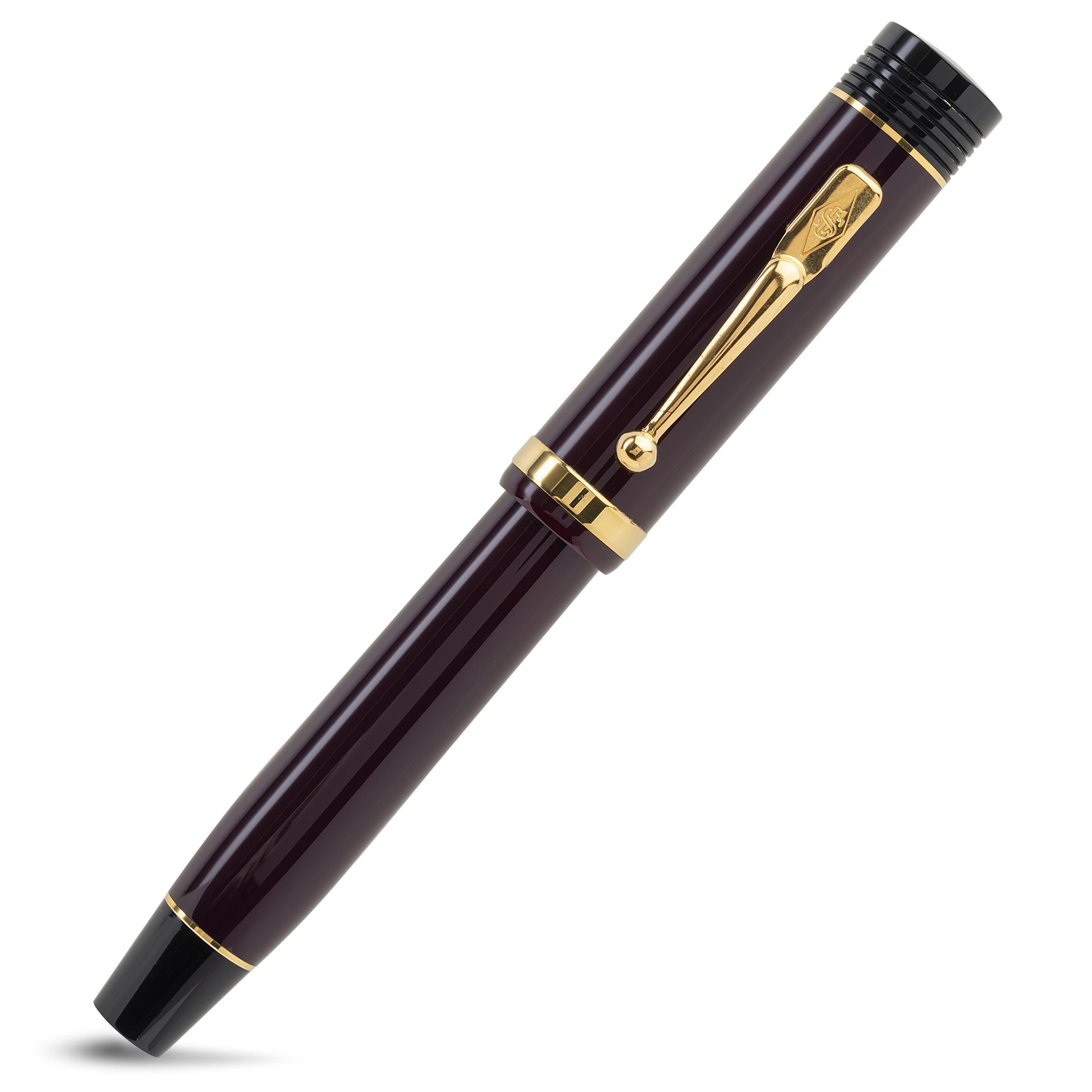 Churchill Bordeaux ballpoint pen capped, diagonal view of the burgundy barrel with gold bands and clip
