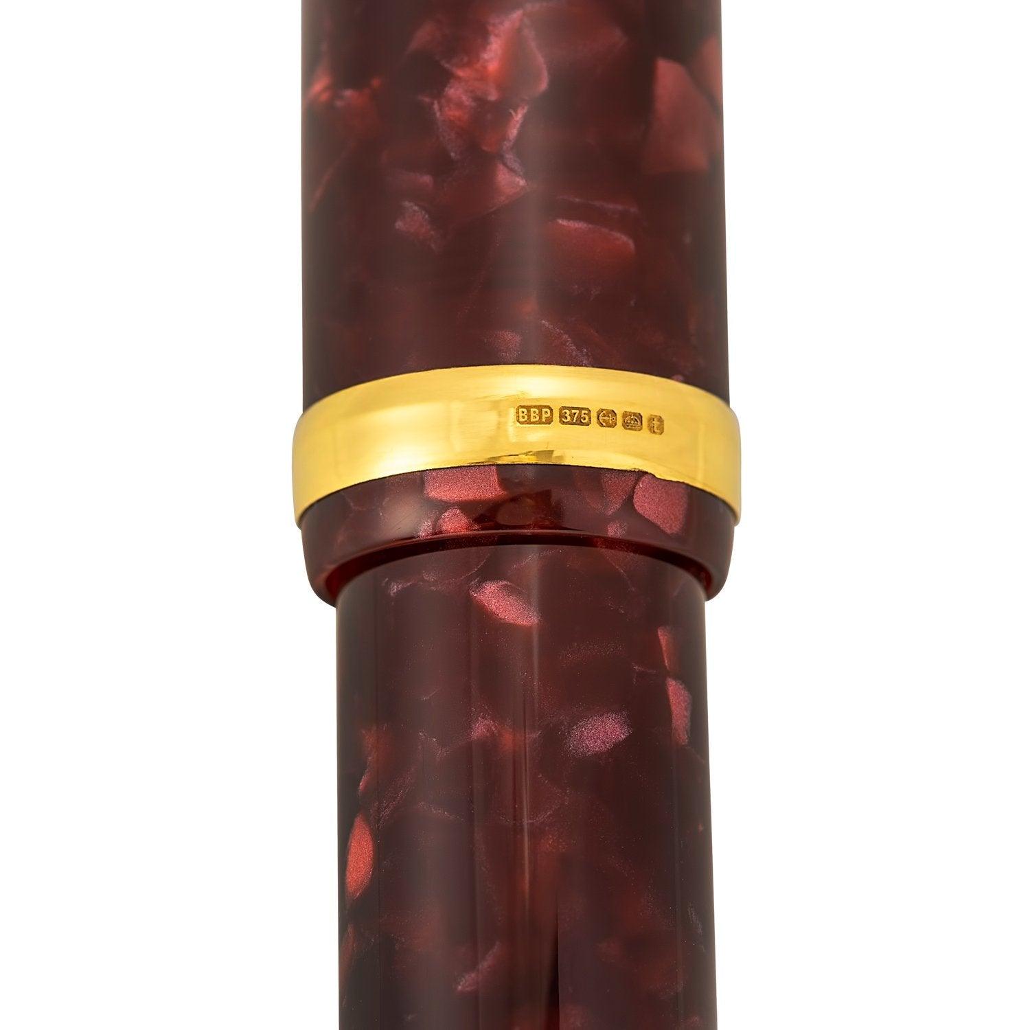 Close-up of the gold cap band showing hallmark stamps on the Churchill Burgundy pen