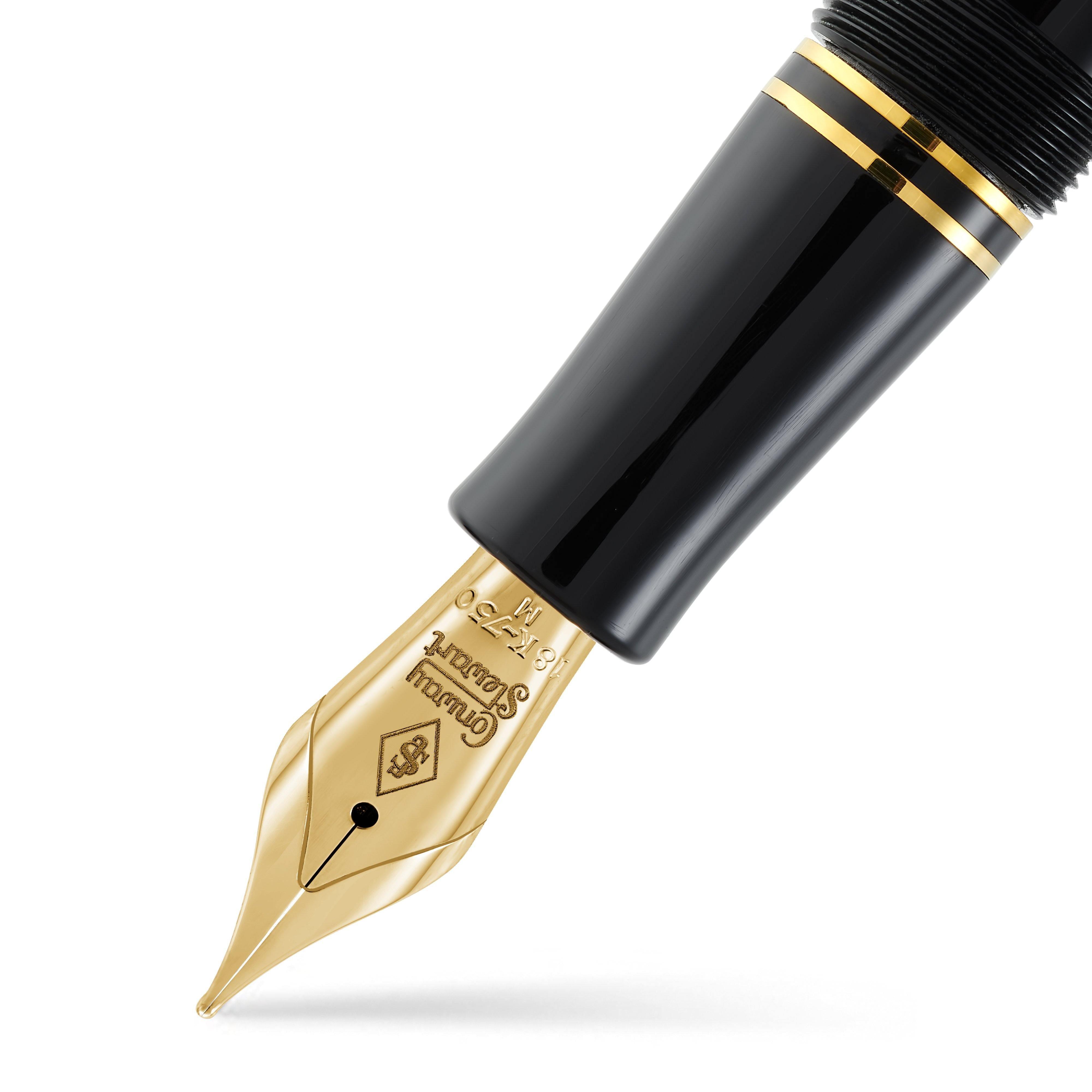 Close-up of the Churchill Classic Black Lever-Fill gold nib beneath the black cap and gold bands