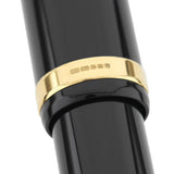 Close-up of the gold cap band hallmark on the Churchill Classic Black Lever-Fill pen