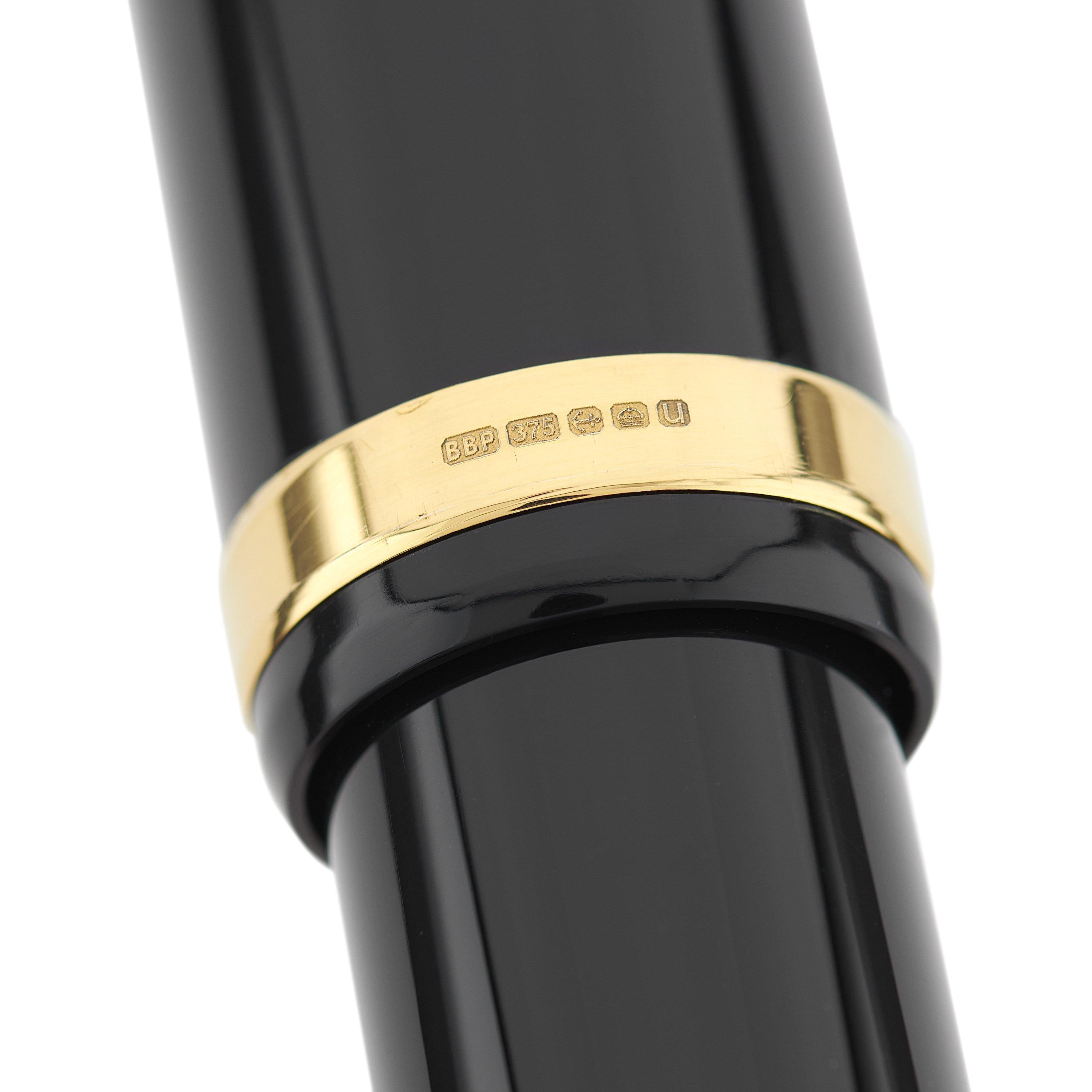 Close-up of the gold cap band hallmark on the Churchill Classic Black Lever-Fill pen