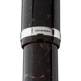 Close-up of Churchill Dartmoor Silver cap band hallmark stamps reading CS 925 on tortoiseshell acrylic