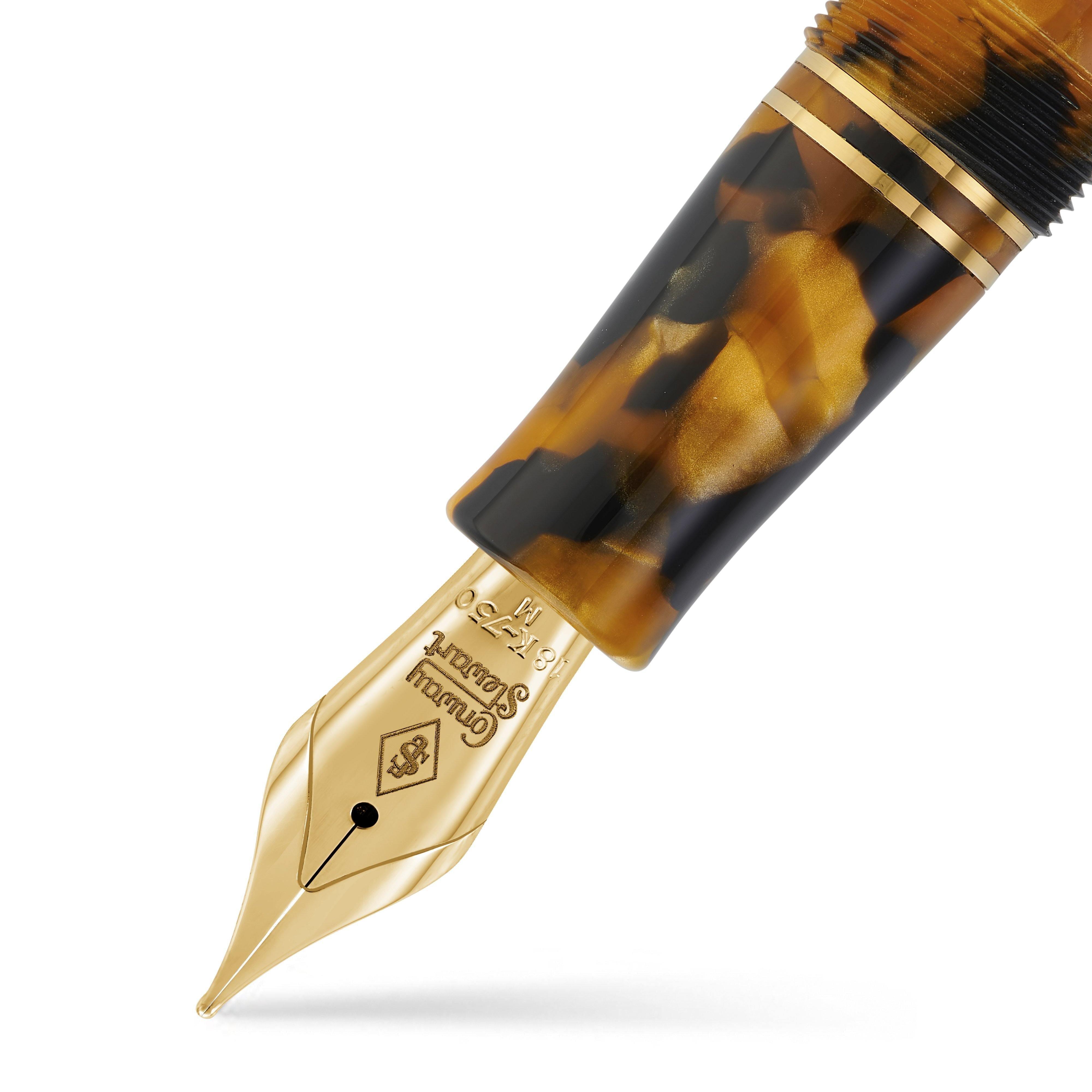 Close-up of the Churchill Honey Noire Lever-Fill gold nib beneath the mottled cap and gold bands