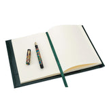 Green leather Conway Stewart notebook open to ruled pages, with a marbled fountain pen and ribbon marker