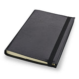 Black leather Conway Stewart notebook closed, angled view showing the elastic strap