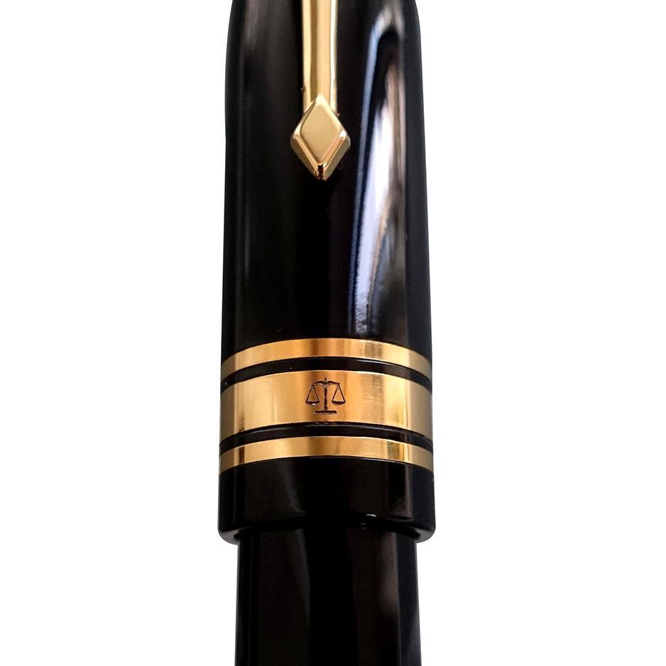 Close-up of the Series 100 Lawyer's Pen cap band, engraved with scales of justice between gold rings