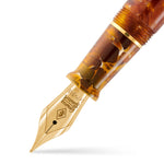 Macro view of the gold nib and amber marbled section on the Series 58 Amber fountain pen