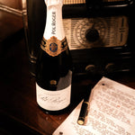 The Pol Roger pen resting on a speech beside Pol Roger champagne