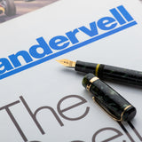 Vanwall fountain pen and cap resting on a Vandervell motor racing brochure