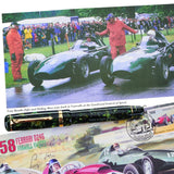 Vanwall fountain pen resting among motor racing photographs and a Vanwall commemorative stamp