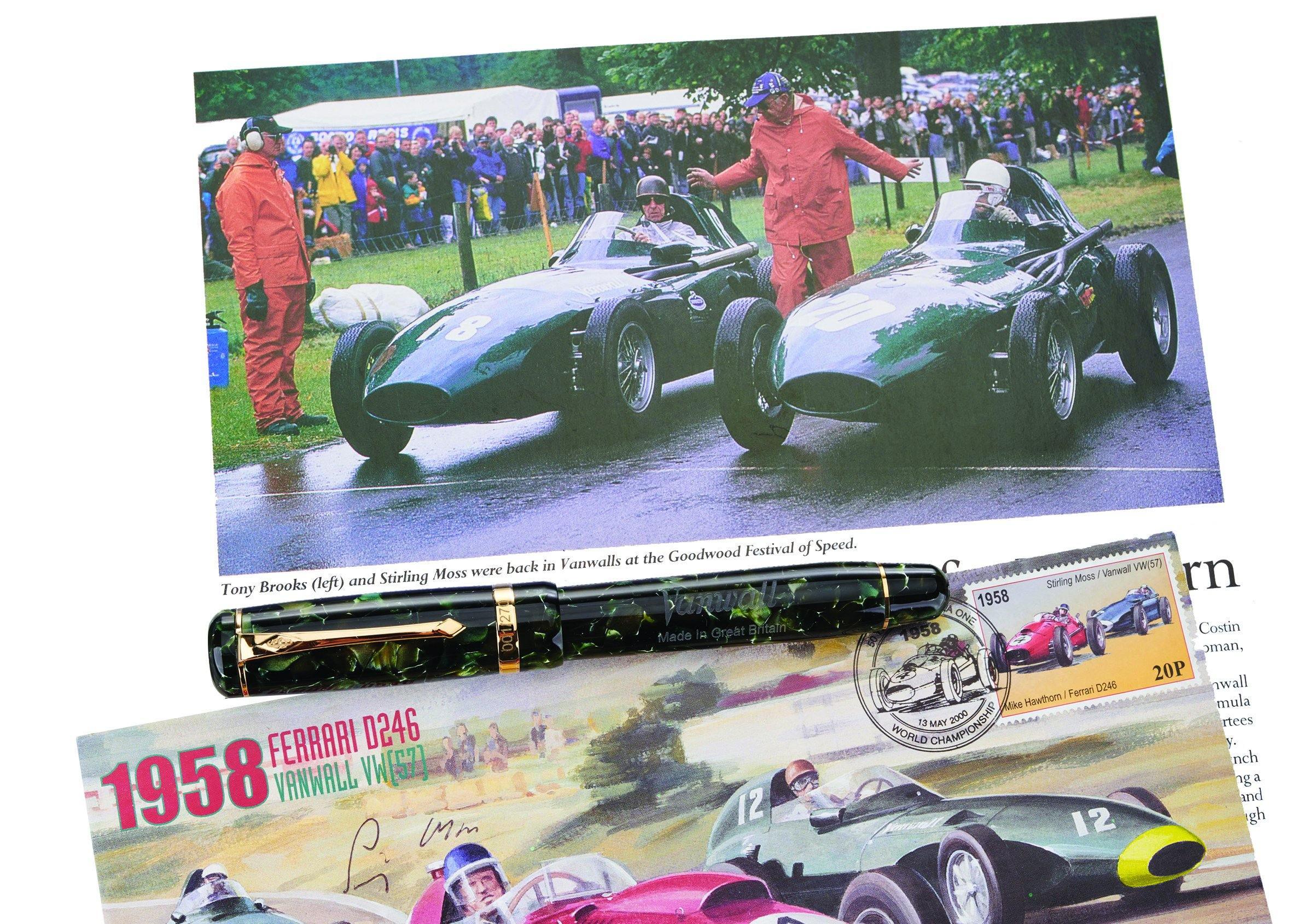 Vanwall fountain pen resting among motor racing photographs and a Vanwall commemorative stamp