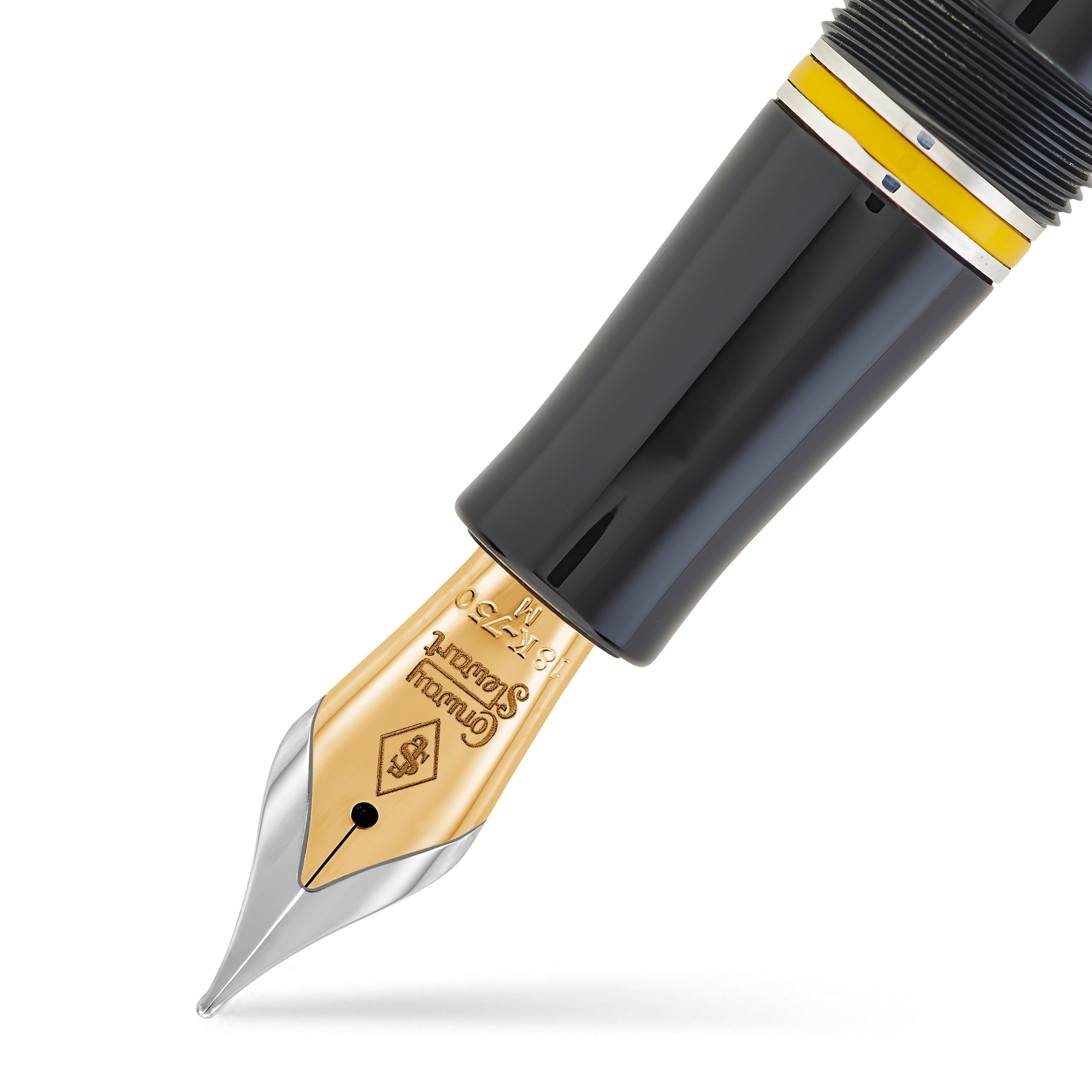 Macro view of the gold nib, silver cap band and yellow cap ring of the Alan Turing Pen